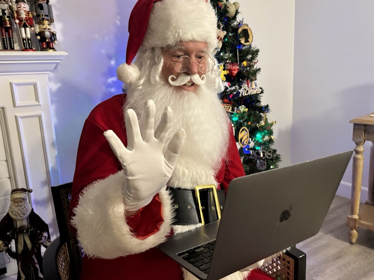 Santa waving on a video call